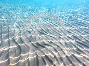 Clear water. underwater background with sandy sea bottom. Beautiful texture of the sea and ocean water