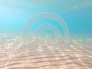 Clear water. underwater background with sandy sea bottom. Beautiful texture of the sea and ocean water