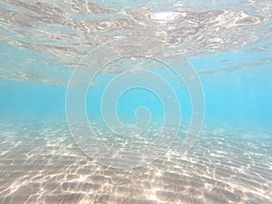 Clear water. underwater background with sandy sea bottom. Beautiful texture of the sea and ocean water