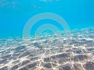 Clear water. underwater background with sandy sea bottom. Beautiful texture of the sea and ocean water