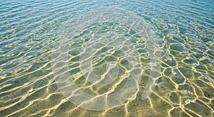 Clear water with visible sandy bottom,