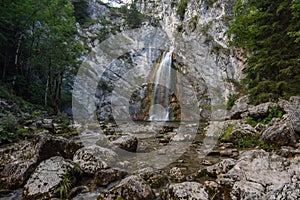 clear waterfall with rocks on the ground