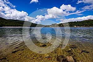 Clear waters of a lake under an intense blue sky