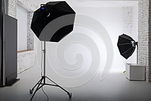 Clear white cyclorama. Light background with with professional lighting equipment. Plain wall empty photo studio.