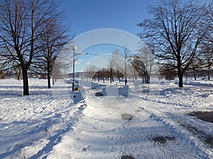 Cleared of snowdrifts pedestrian path on the embankment