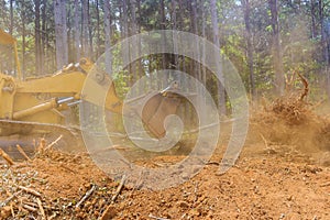 Clearing land from roots for a subdivision using tractors skid steers