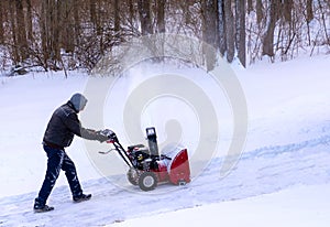 Clearing snow from a drivway using snowblower