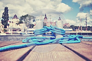 Cleat with blue rope on a wooden pier in Szczecin, Poland.