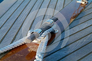 Cleat and rope on a wooden sailboat