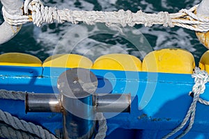 Cleat and safety fence rope on gunnel on board island ferry near coastalline in Geoje island, South Korea.