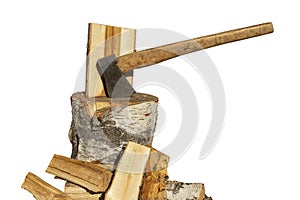 Cleaved birch firewood and an ax in a birch chopping block.