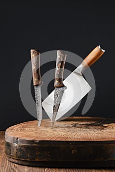 Cleaver and knives stick out of wooden blockhead