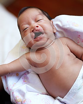 Cleft lip, baby and child birth with a portrait of a newborn crying in her crib at home. Childcare, young and infant