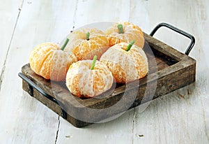 Clementine Oranges Decorated Like Pumpkins photo