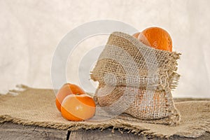 Clementine in a rustic bag on a wooden table