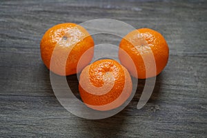 Clementines or mandarin oranges on rustic wooden table