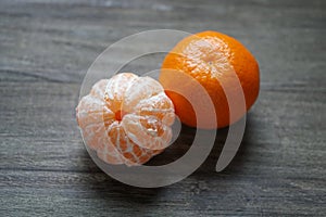 Clementines or tangerines or mandarin oranges on rustic wooden table