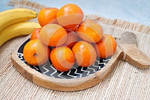 Clementines in a wooden bowl