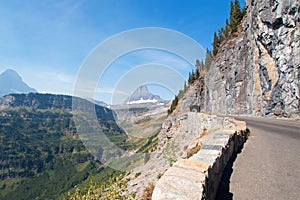 CLEMENTS AND BEARHAT MOUNTAIN PEAKS ON THE GOING TO THE SUN HIGHWAY UNDER CIRRUS CLOUDS IN GLACIER NATIONAL PARK USA