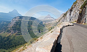 CLEMENTS AND BEARHAT MOUNTAIN PEAKS ON THE GOING TO THE SUN HIGHWAY UNDER CIRRUS CLOUDS IN GLACIER NATIONAL PARK USA photo