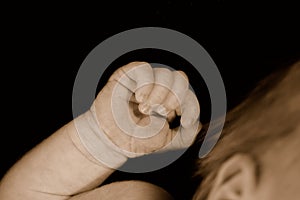 Clenched hand of newborn baby