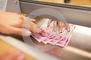 Clerk giving cash money to customer at bank office