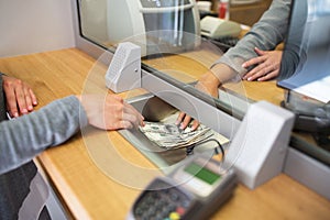 Clerk giving cash money to customer at bank office