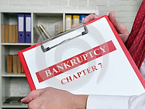 Clerk holds bankruptcy chapter 7 documents about insolvency.