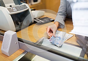 Clerk with swiss francs cash money at bank office