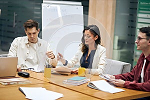 Clever attractive brunette woman telling her colleagues about new opportunities