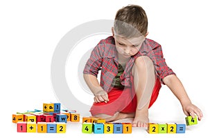 Clever boy with blocks on the floor