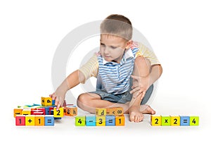 Clever boy with blocks on the floor