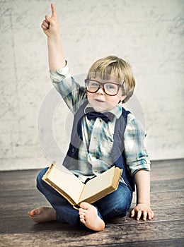 Clever boy reading a novel