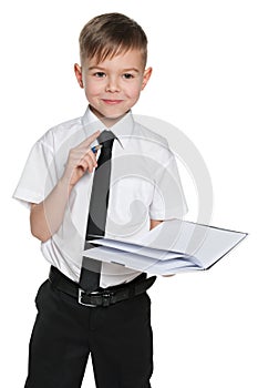 Clever boy in white shirt with a notebook