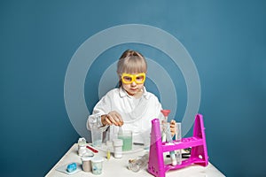 Clever child student wearing uniform and glasses with science experiment