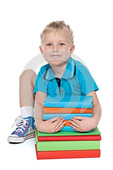 Clever cute little boy with books