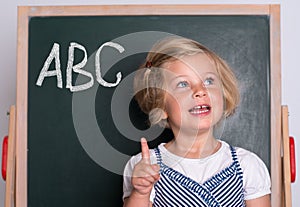 Clever girl in front of black board