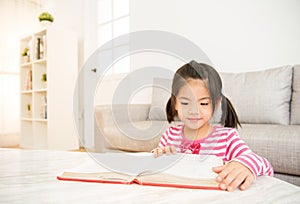 Clever girl at table with reading books