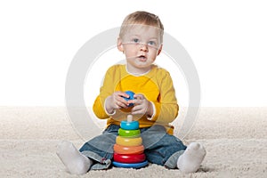 Clever infant boy with a toy