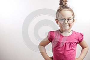 Clever kid with hairbun posing to the camera