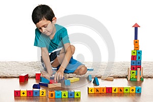 Clever little boy with toys on the floor