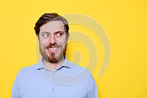 Clever man face expression isolated on yellow
