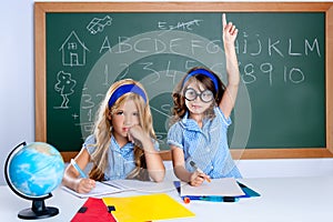 Clever nerd student girl in classroom raising hand