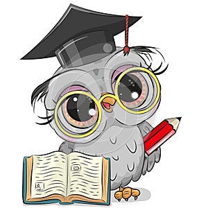 Clever owl with pencil, book and in graduation cap photo