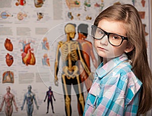 Clever pretty young girl in glasses