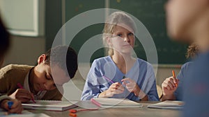 Clever schoolboys and schoolgirls studying science together at school