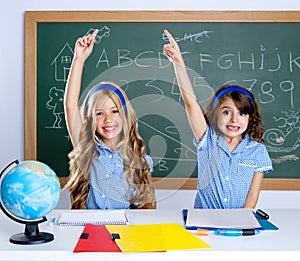 Clever students in classroom raising hand