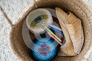 Clews of yarn and spokes in a textile bag. Female hobby. Closeup