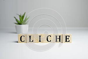 CLICHE word made with building blocks on white.