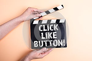 Click like button. Female hands holding movie clapper